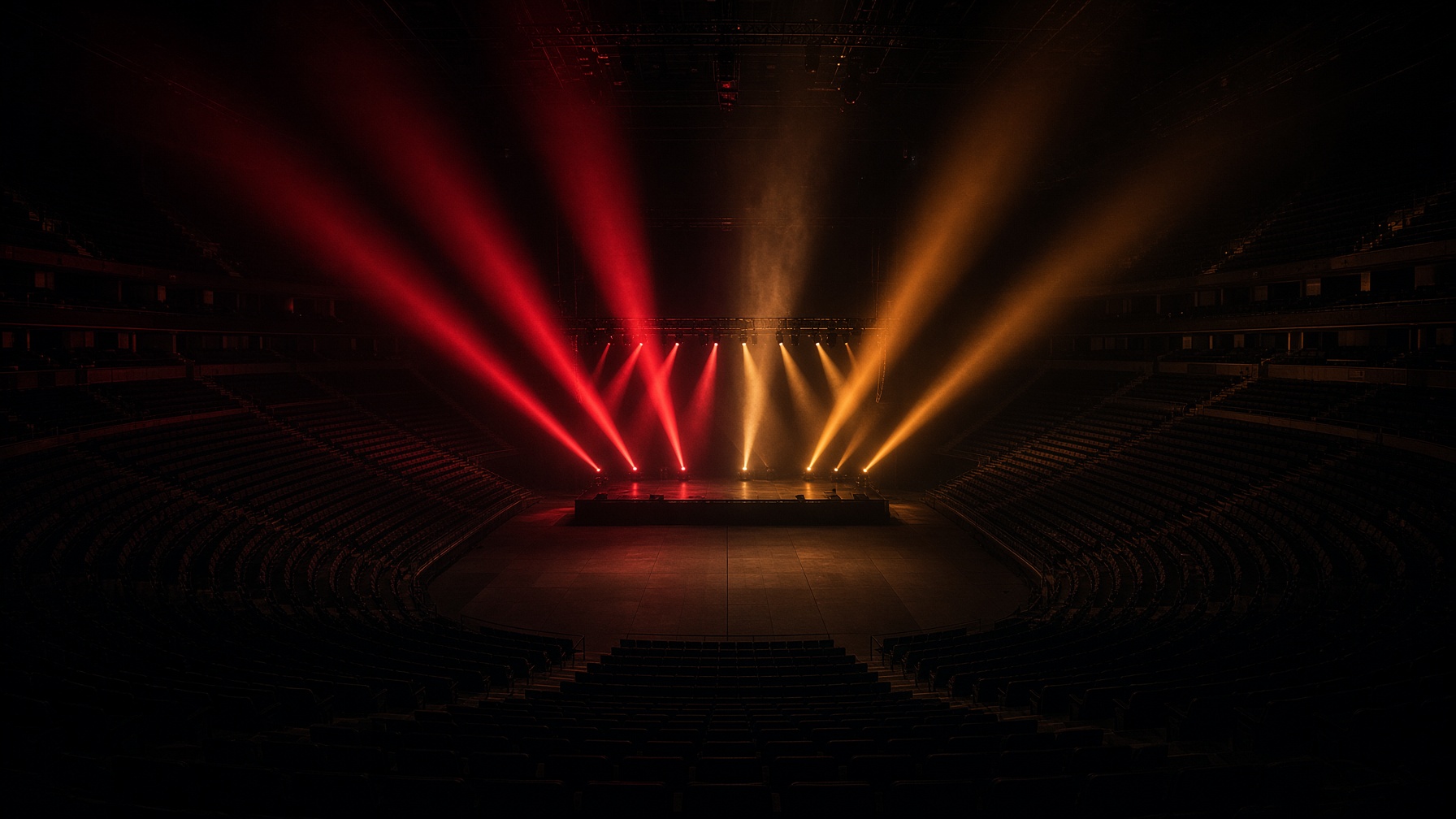 Empty arena with red light on a bare stage